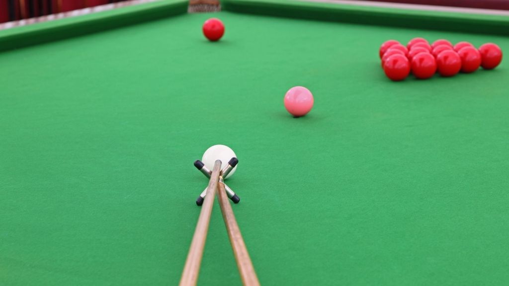 Playing Snooker on Pool Table