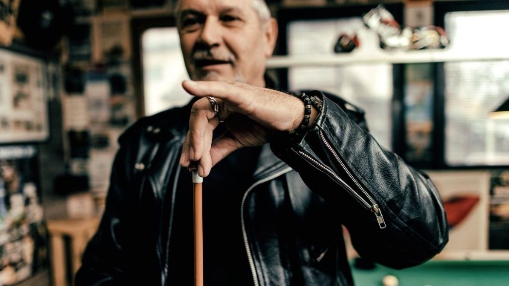 Man Holding a Sneaky Pete Pool Cue