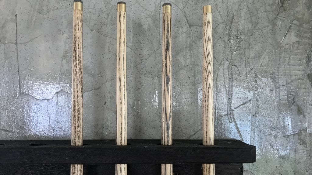 Four Wooden Pool Cues